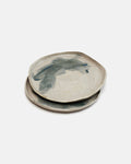 Two ceramic coasters with a handprint design on a white background