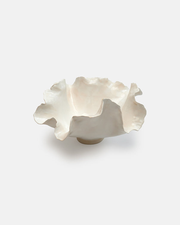 White ceramic bowl with wavy edge on a white background