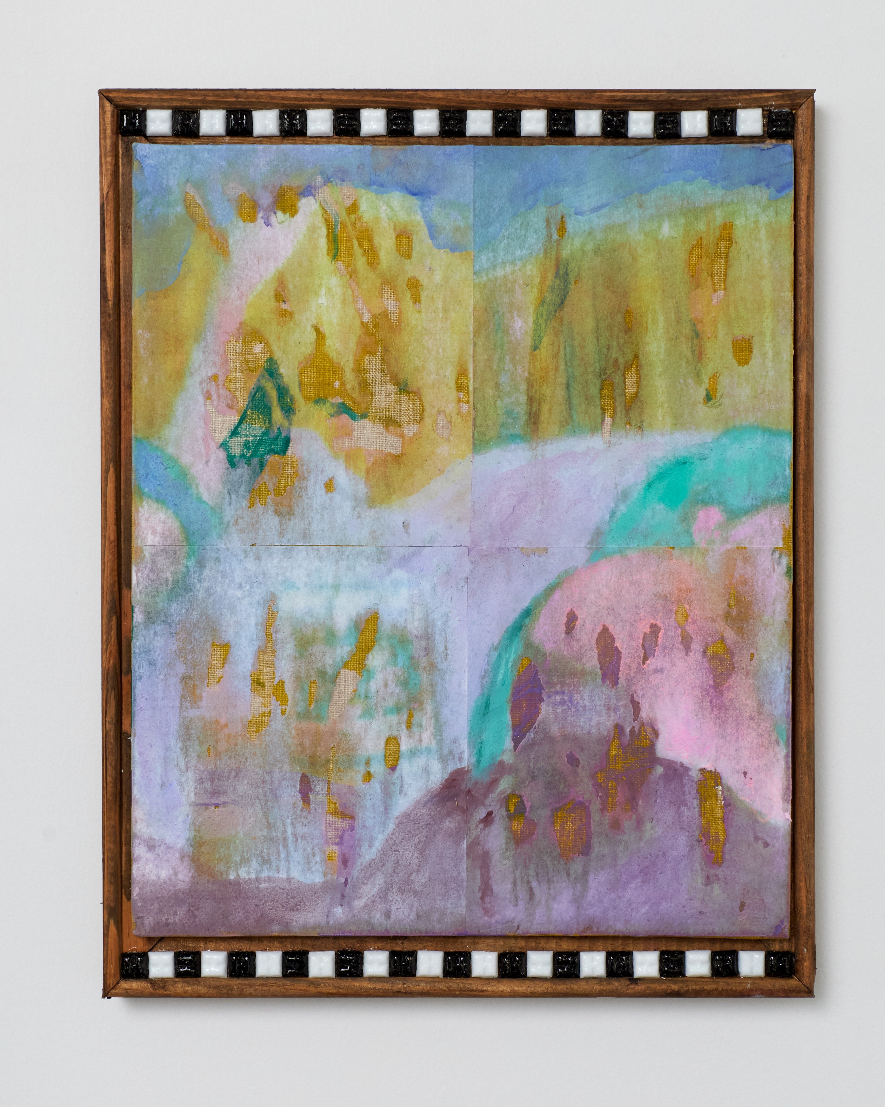 Abstract painting with colorful brush strokes in a wooden frame on a white wall