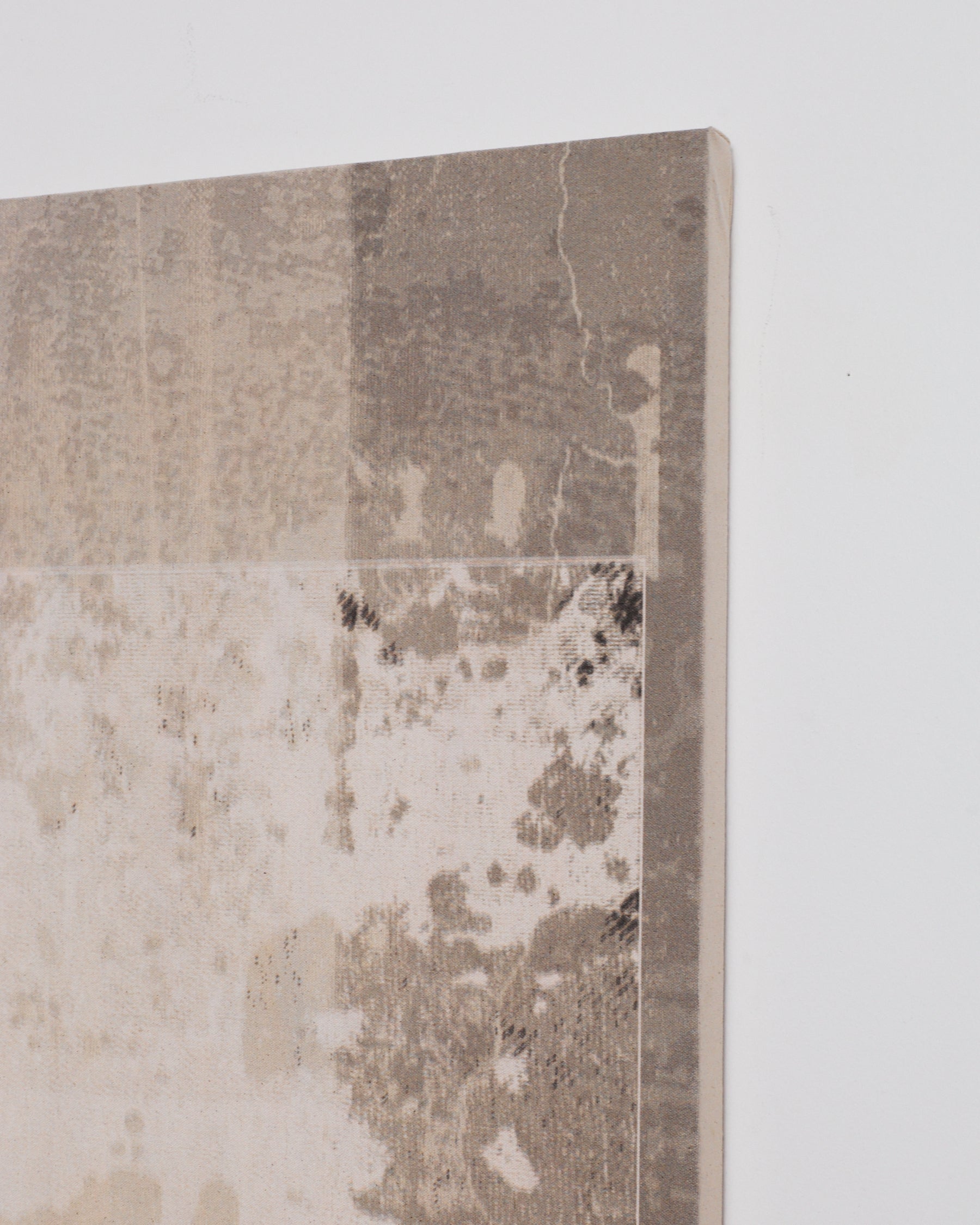 Textured wall panel with a distressed finish on a light gray background