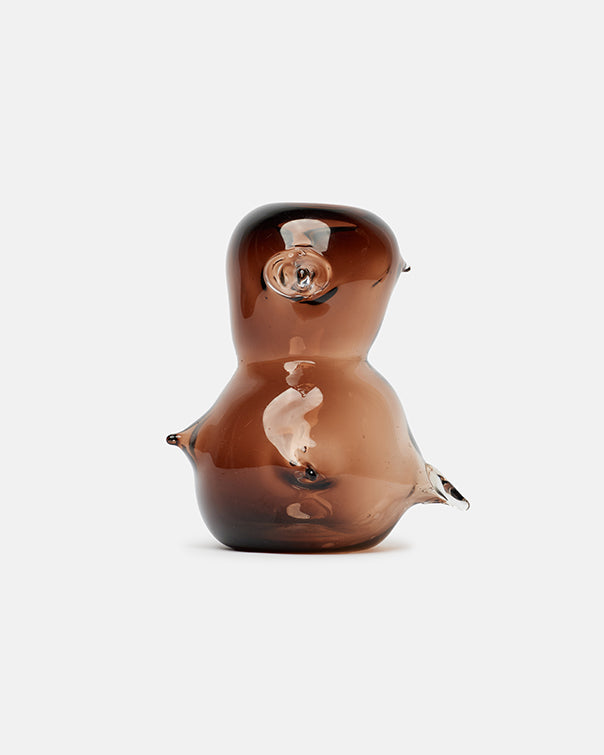 Brown glass bird-shaped object on a white background