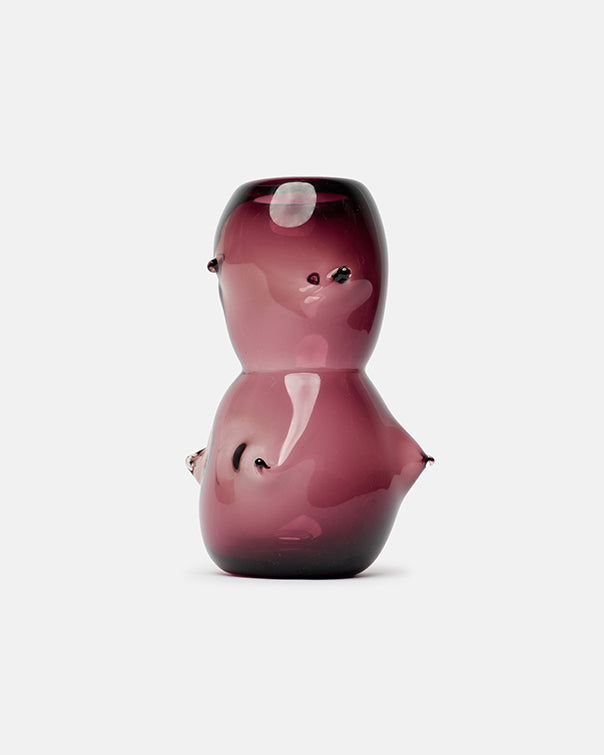 Pink glass figurine on a white background