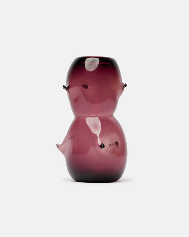 Glass figurine with a maroon gradient on a white background