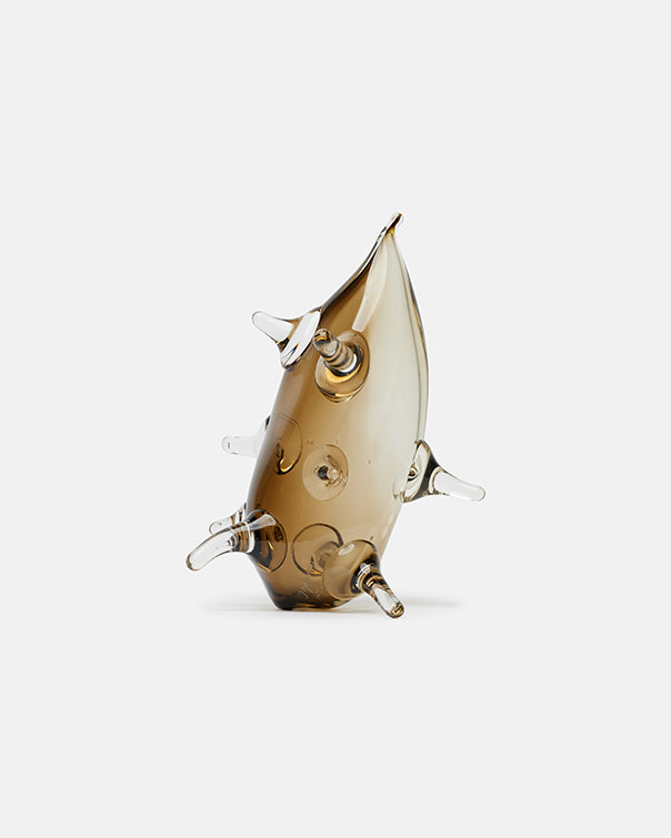 Glass sculpture of a fish on a white background