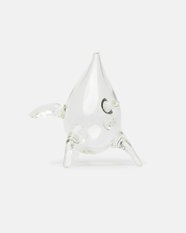 Clear glass narwhal figurine on a white background