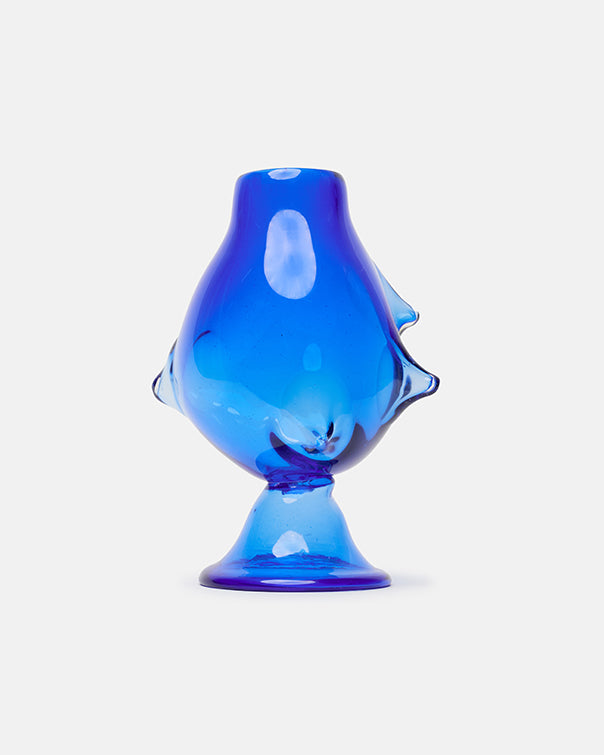 Blue glass fish-shaped object on a white background