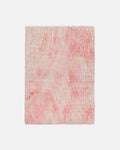 Pink and white textured fabric on a light gray background