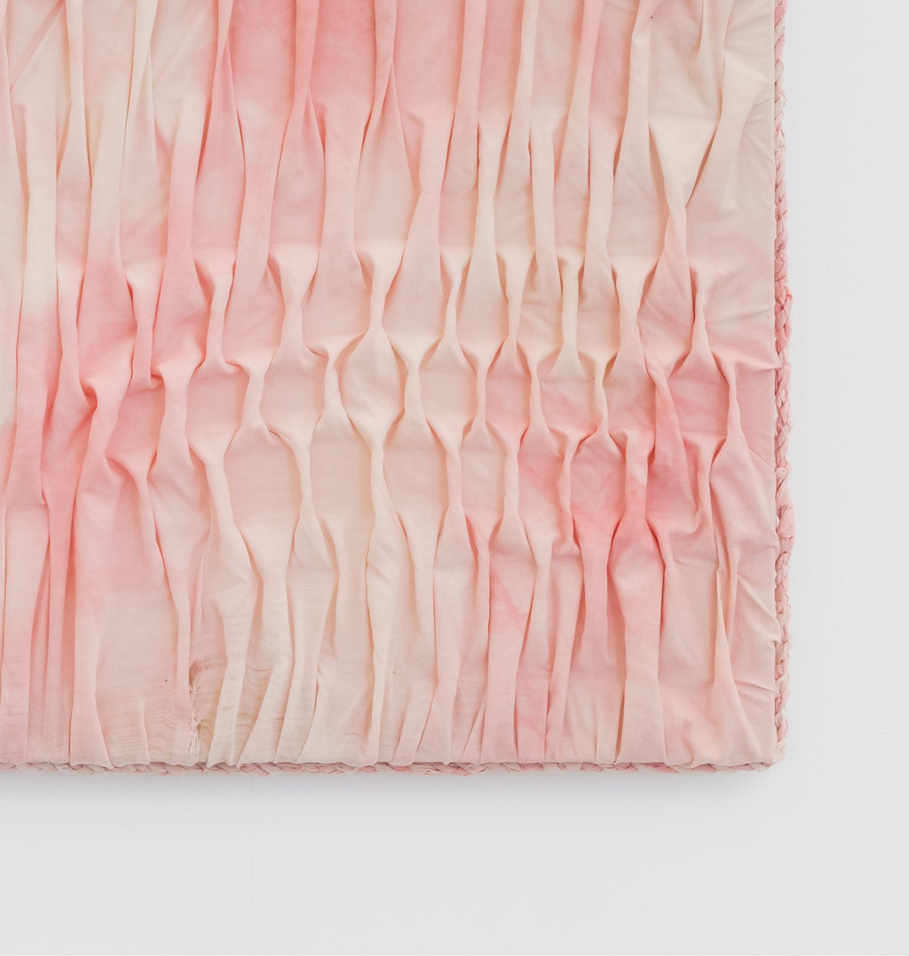 Pink textured fabric on a white background