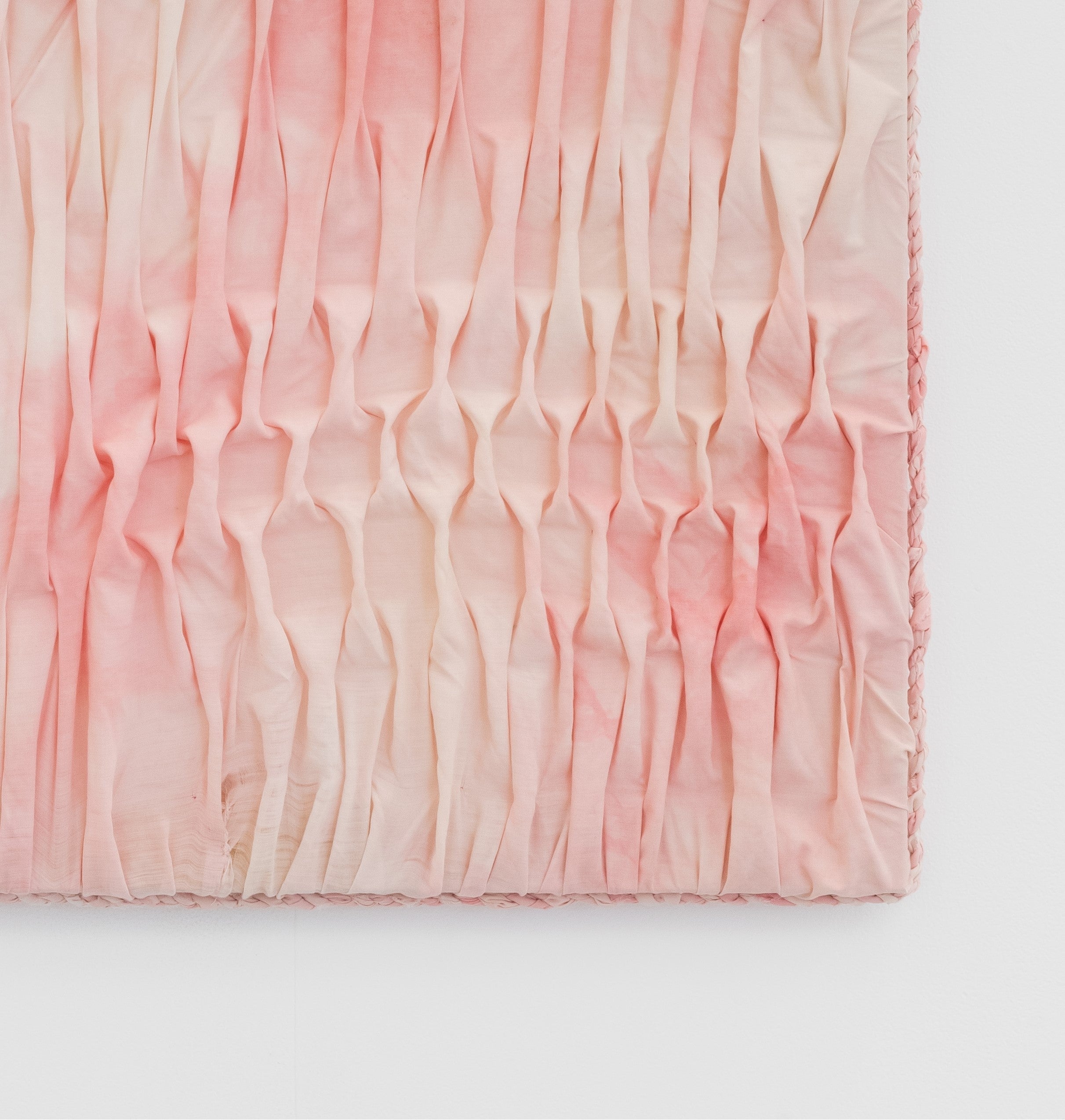 Pink textured fabric on a white background