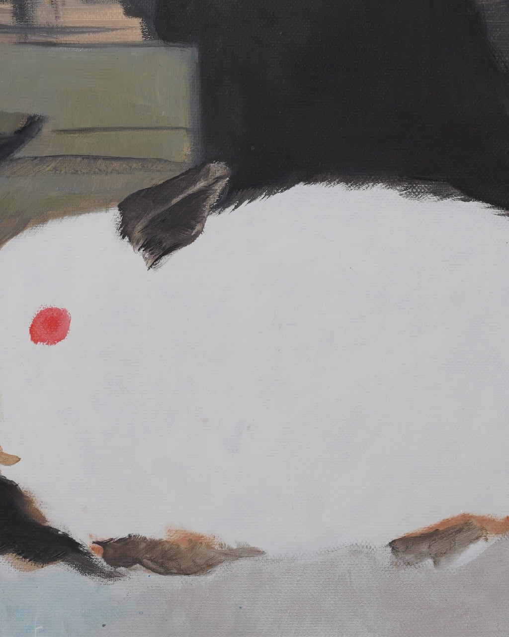 Close-up of a black bird with a red spot on a snowy ground