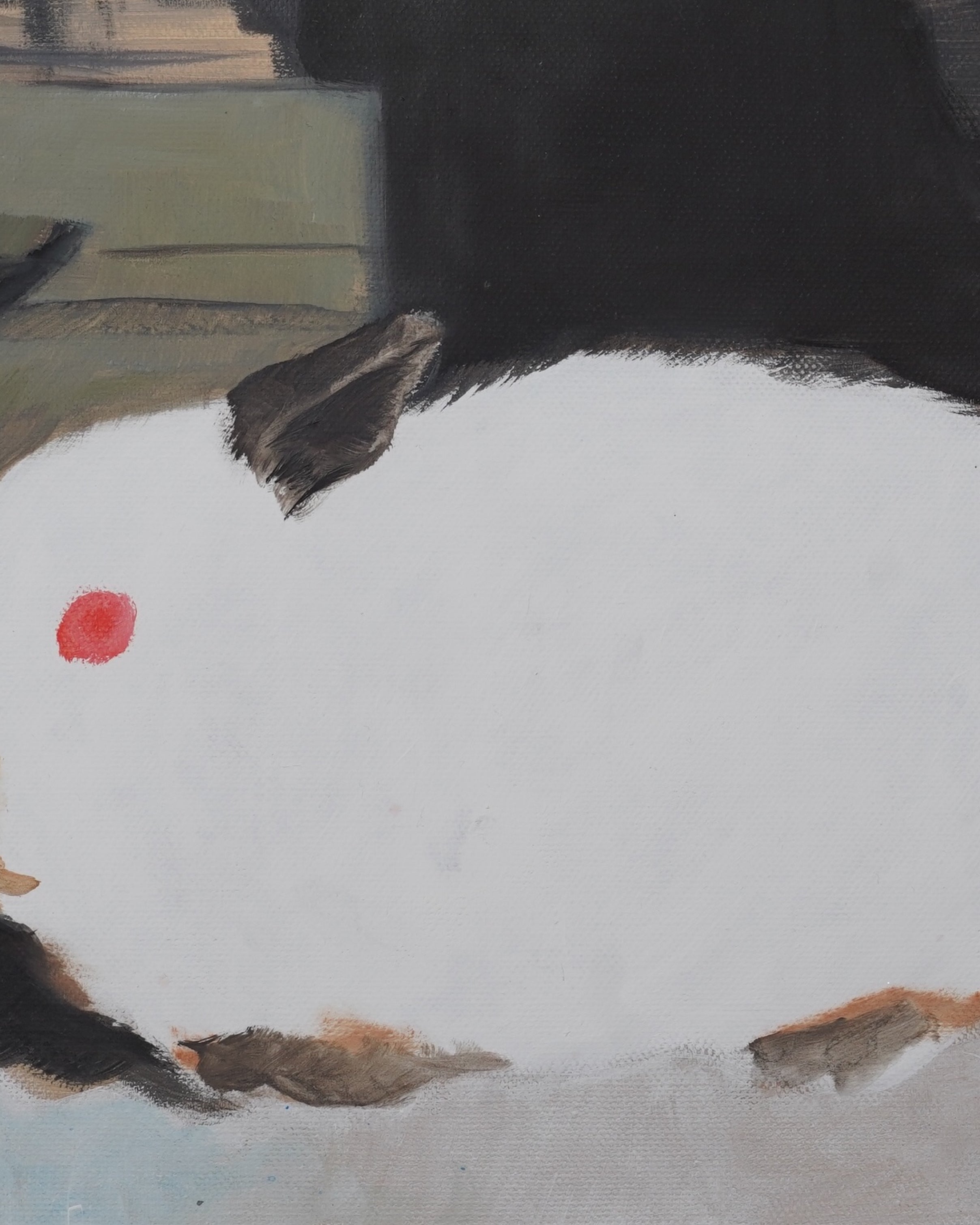 Close-up of a black bird with a red spot on a snowy ground