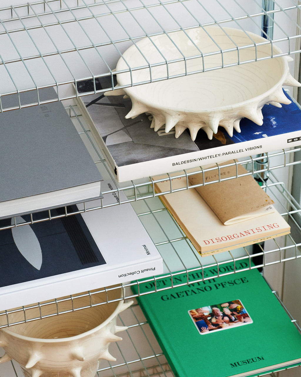Wire shelving unit with books and decorative items