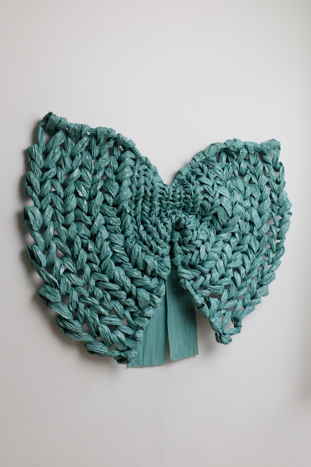 Teal knitted item on a light gray background