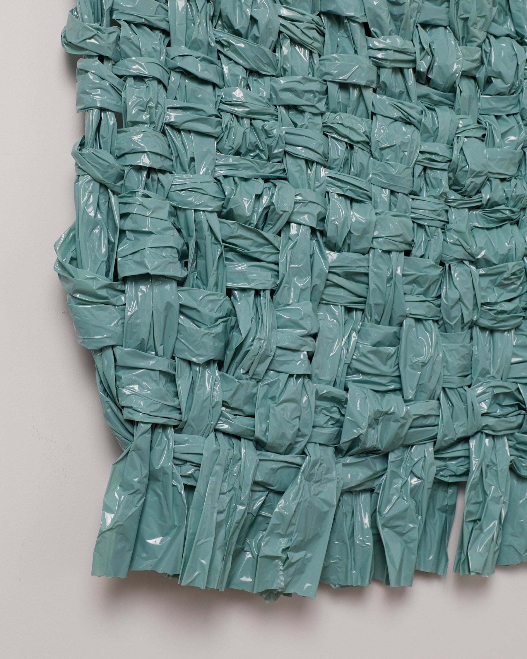 Teal woven mat on a light gray background