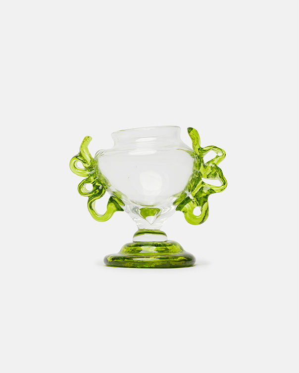 Clear glass vase with green decorative handles on a white background