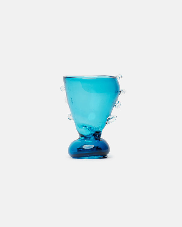 Blue glass vase with decorative elements on a white background