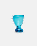 Blue glass vase with bubble-like protrusions on a white background