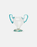 Clear glass cup with turquoise handles on a light gray background