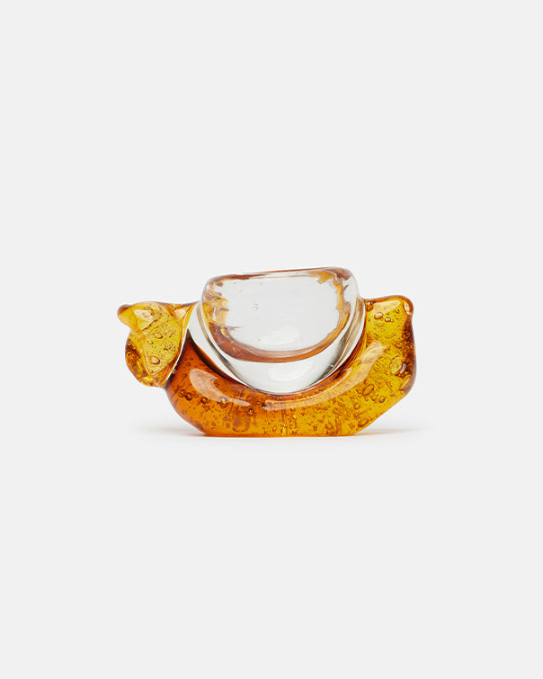 Glass object with amber base and clear top on a white background
