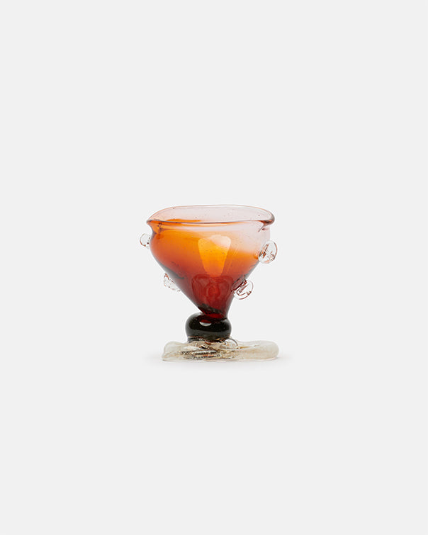 Amber-colored glass object on a white background