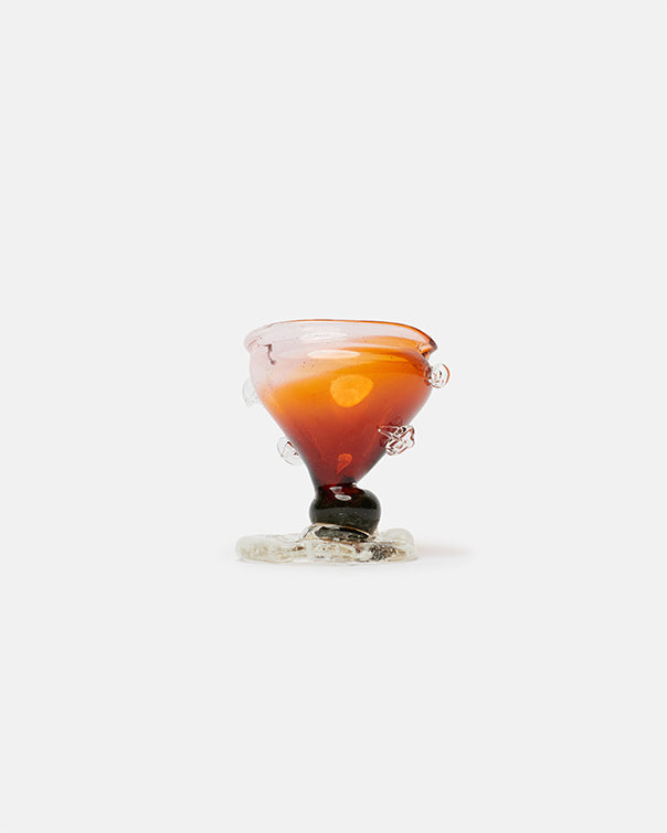 Amber-colored glass with a dark base on a white background