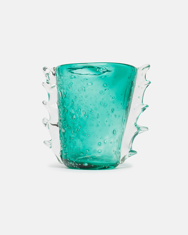 Turquoise glass with textured handle on a white background