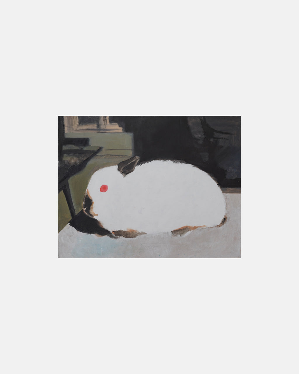 White rabbit with a red dot on its forehead sitting on a surface.