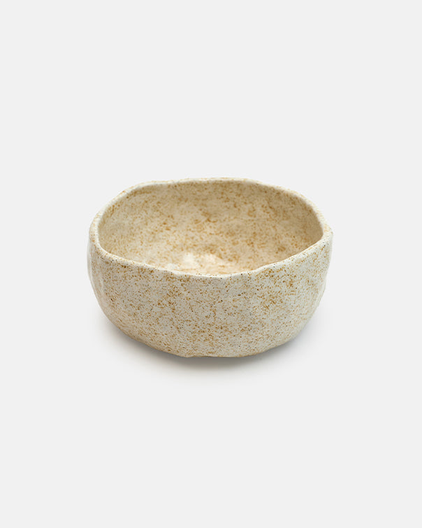 Small ceramic bowl with a textured surface on a white background