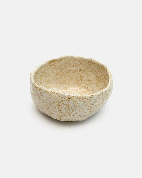 Small ceramic bowl with textured surface on a white background