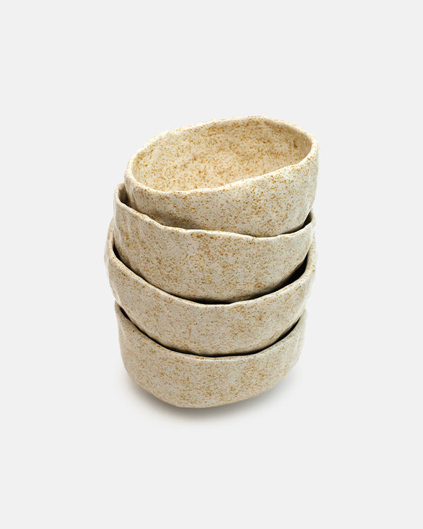 Set of four stacked ceramic bowls on a white background