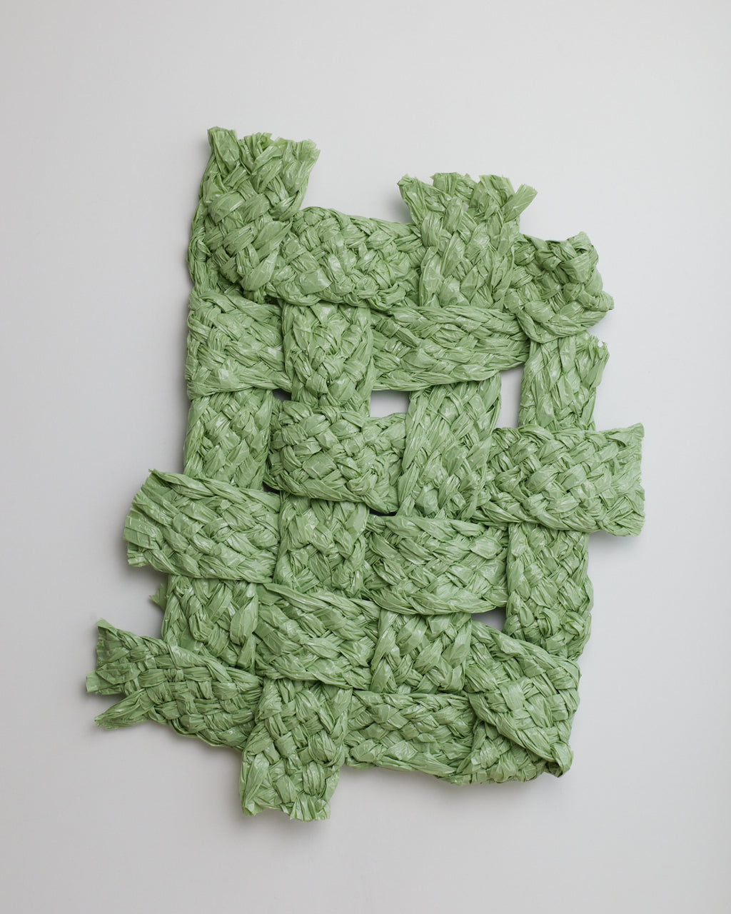 Green woven mat on a light gray background