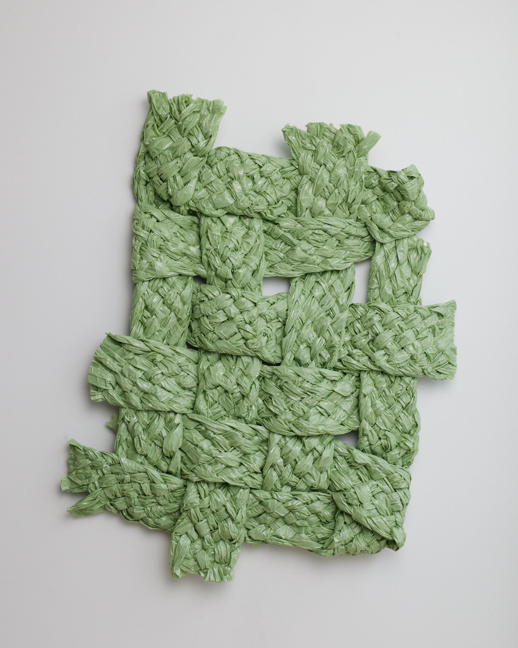 Green woven mat on a light gray background