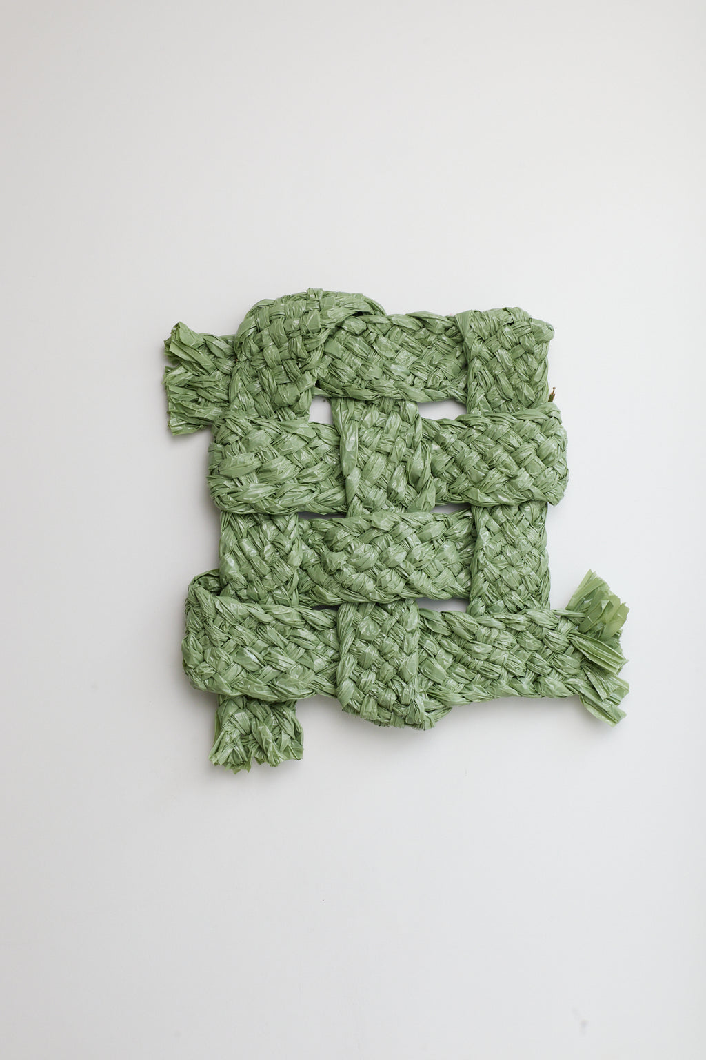 Green knitted scarf on a white background