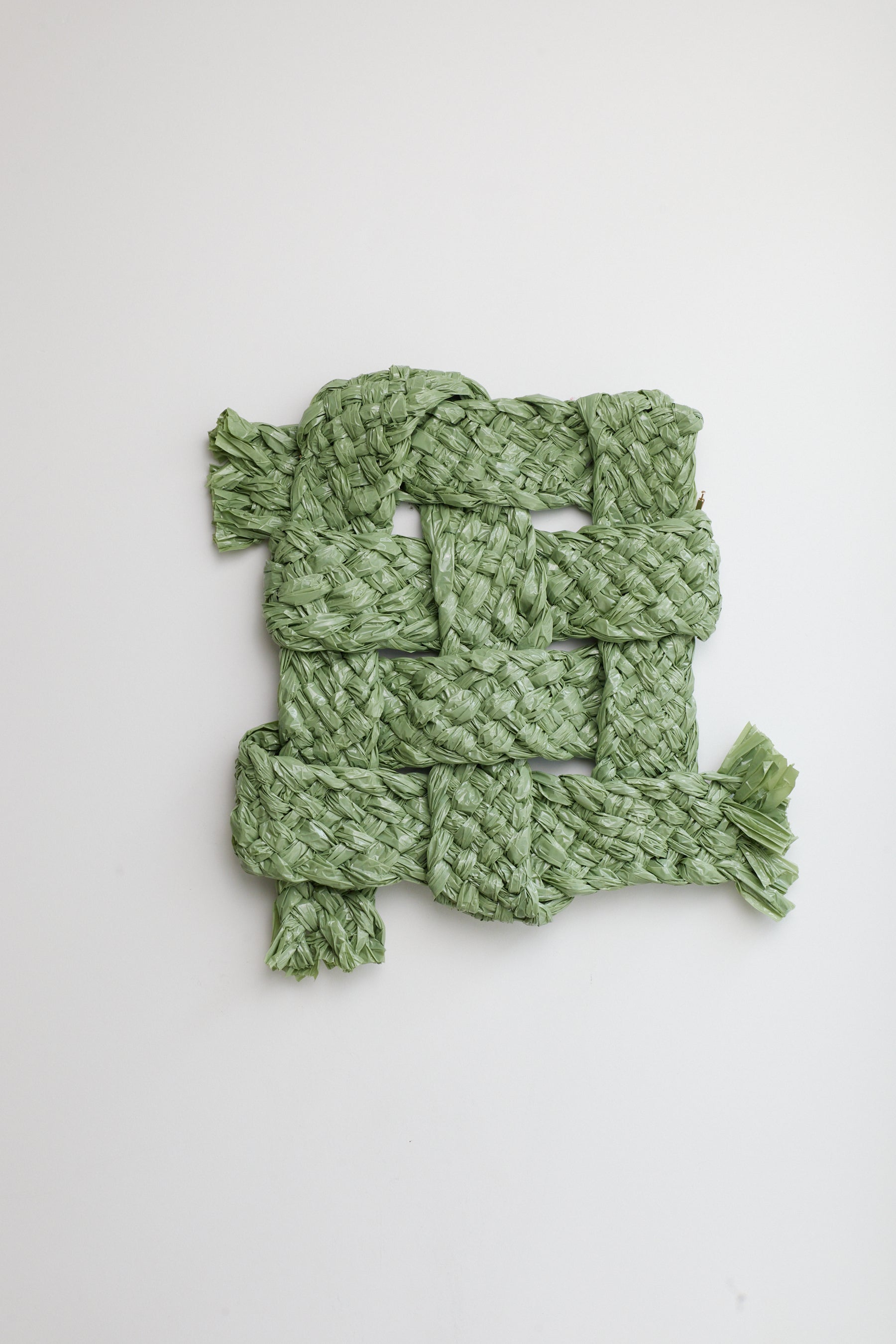 Green knitted scarf on a white background