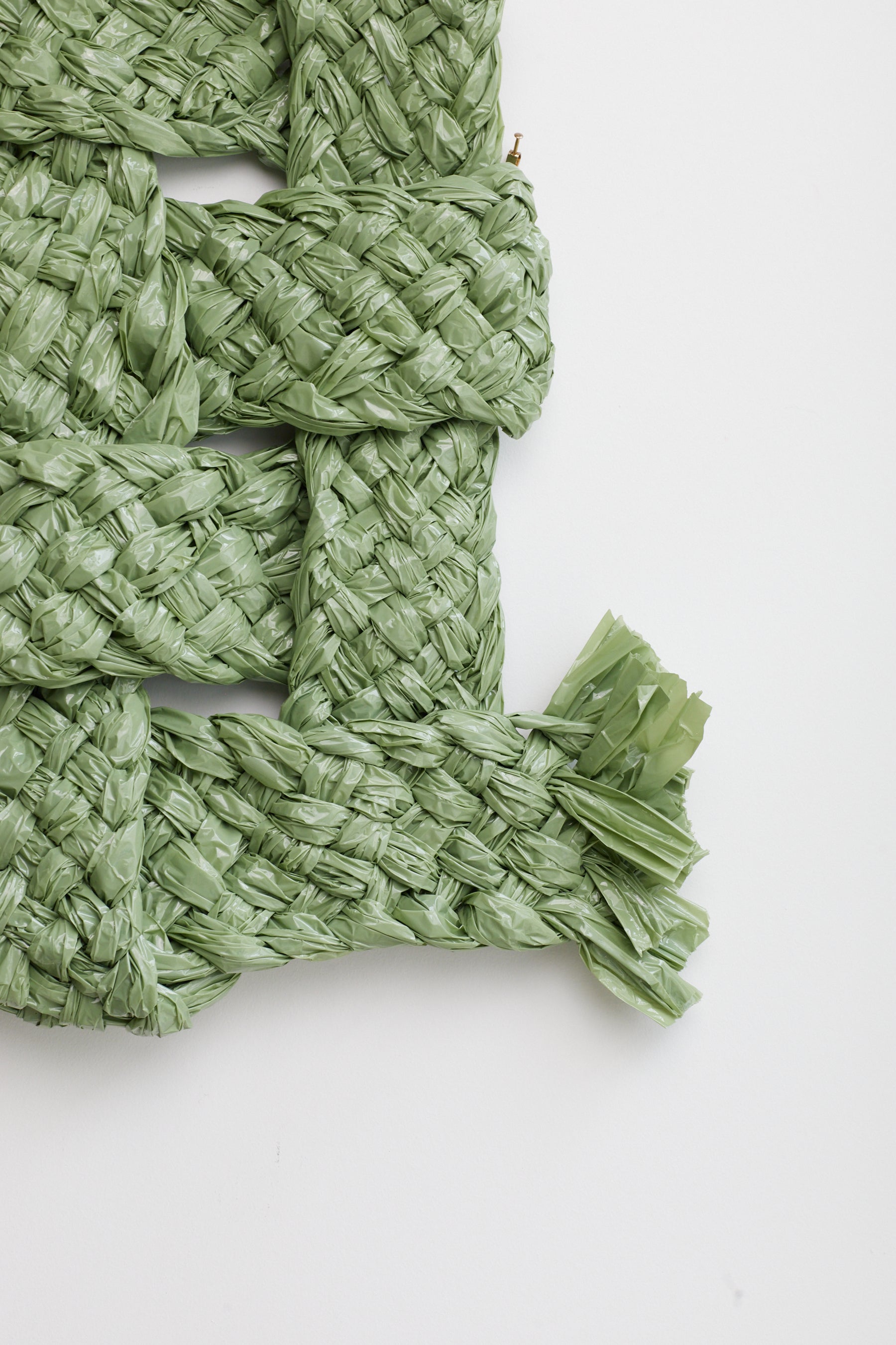 Green woven mat on a white background