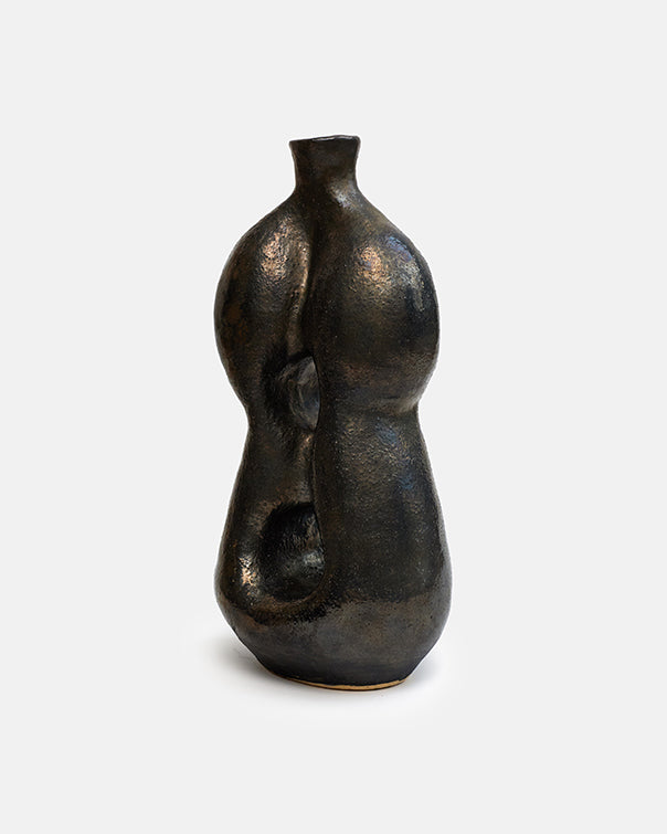 Bronze sculpture of a human figure on a white background