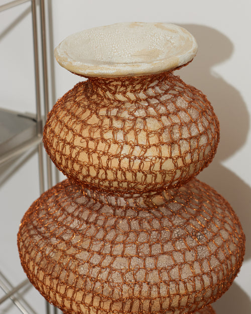Decorative vase with textured design on a white background